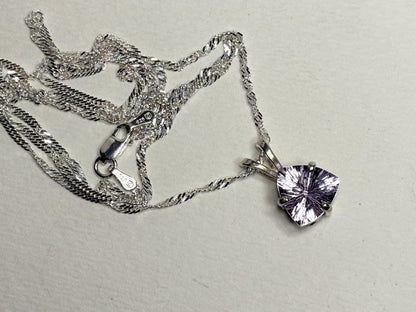 Sterling silver necklace with a trillion-cut kunzite pendant.
