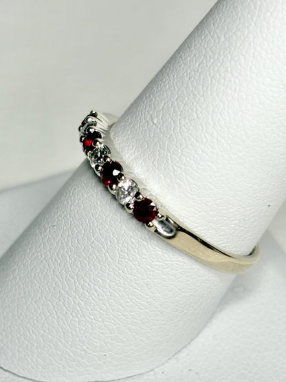 A white gold band ring with alternating rubies and diamonds.