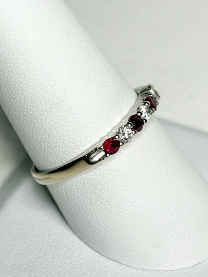 A white gold band ring with alternating rubies and diamonds.