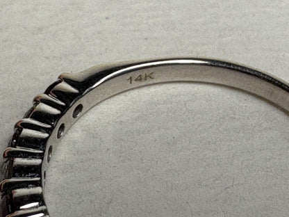 A 14k white gold band ring with rubies and diamonds.