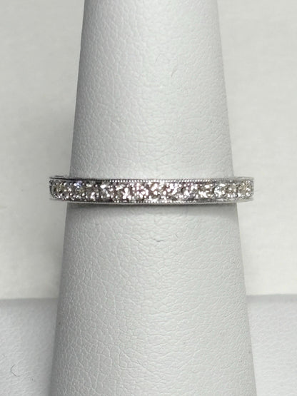 A 14k white gold stackable band ring with .56 ctw diamonds and detailed etching.