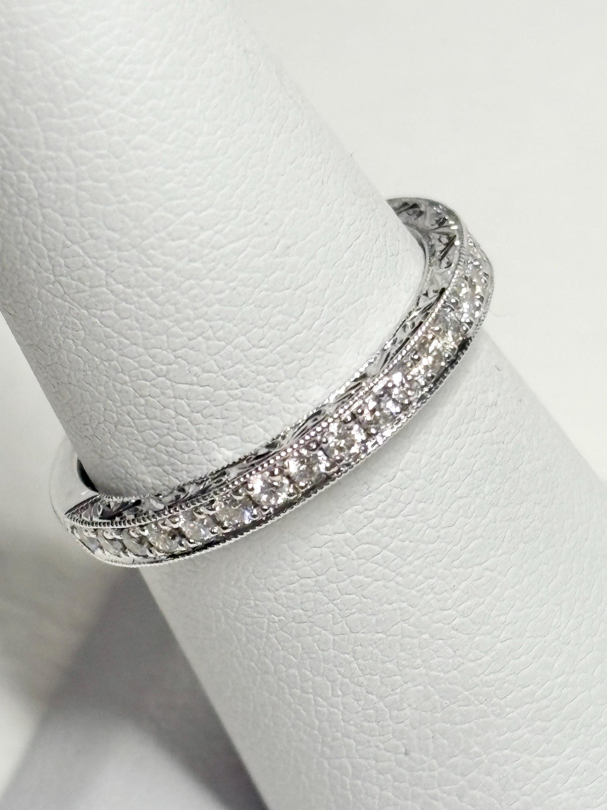 14k white gold band with diamonds and etched detailing.