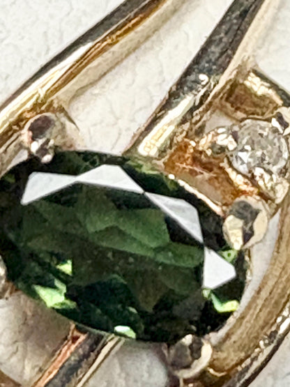 Oval green tourmaline and diamond accent ring in 10k gold.