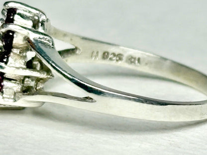 Sterling silver ring with "925" hallmark and a daisy halo design.