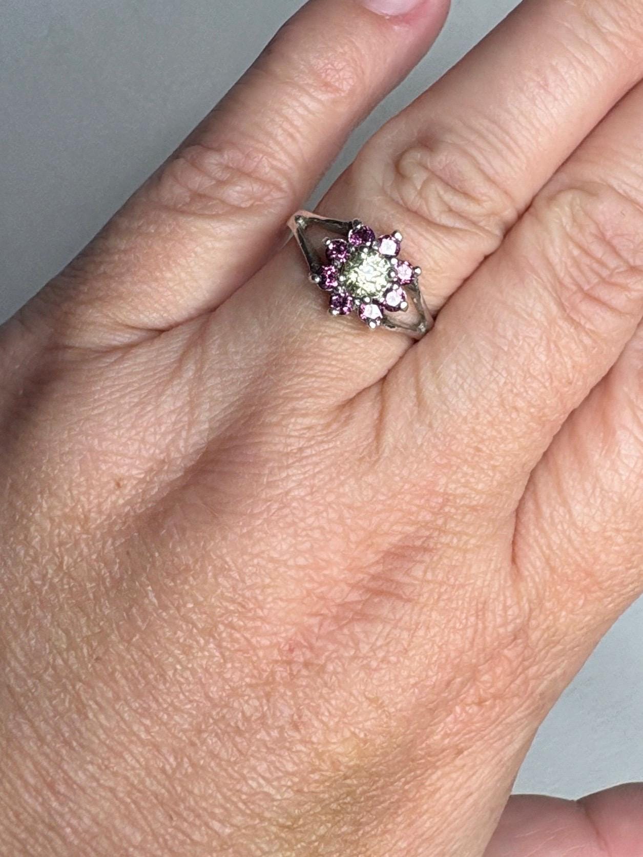 Sterling silver ring with a central Mali garnet surrounded by rhodolite garnets.