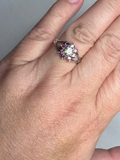 Sterling silver ring with a central Mali garnet surrounded by rhodolite garnets.