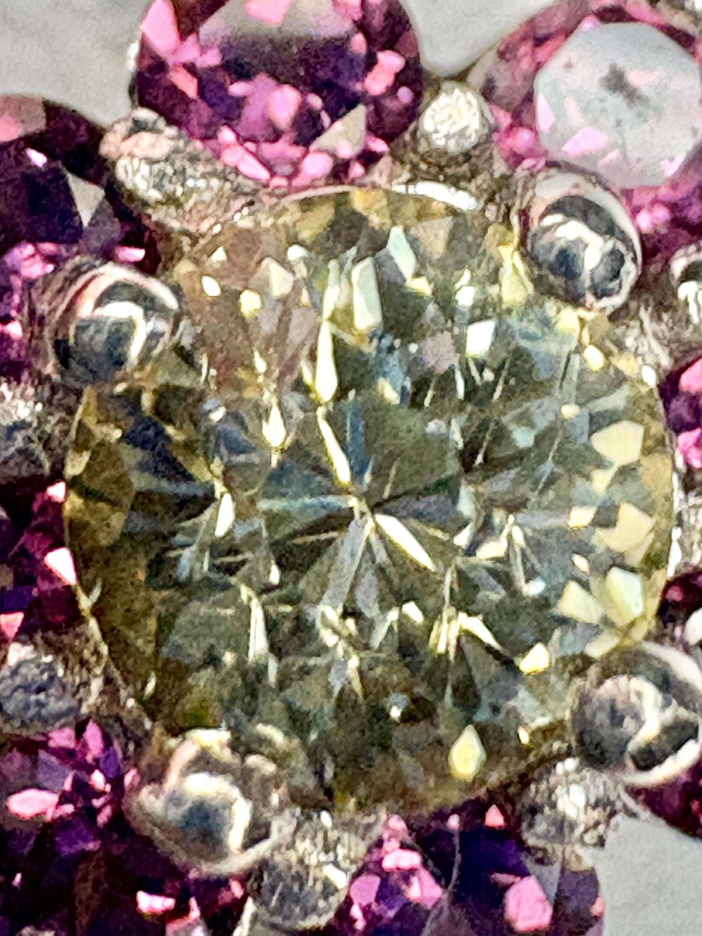 Sterling silver ring with a central Mali garnet surrounded by rhodolite garnets.