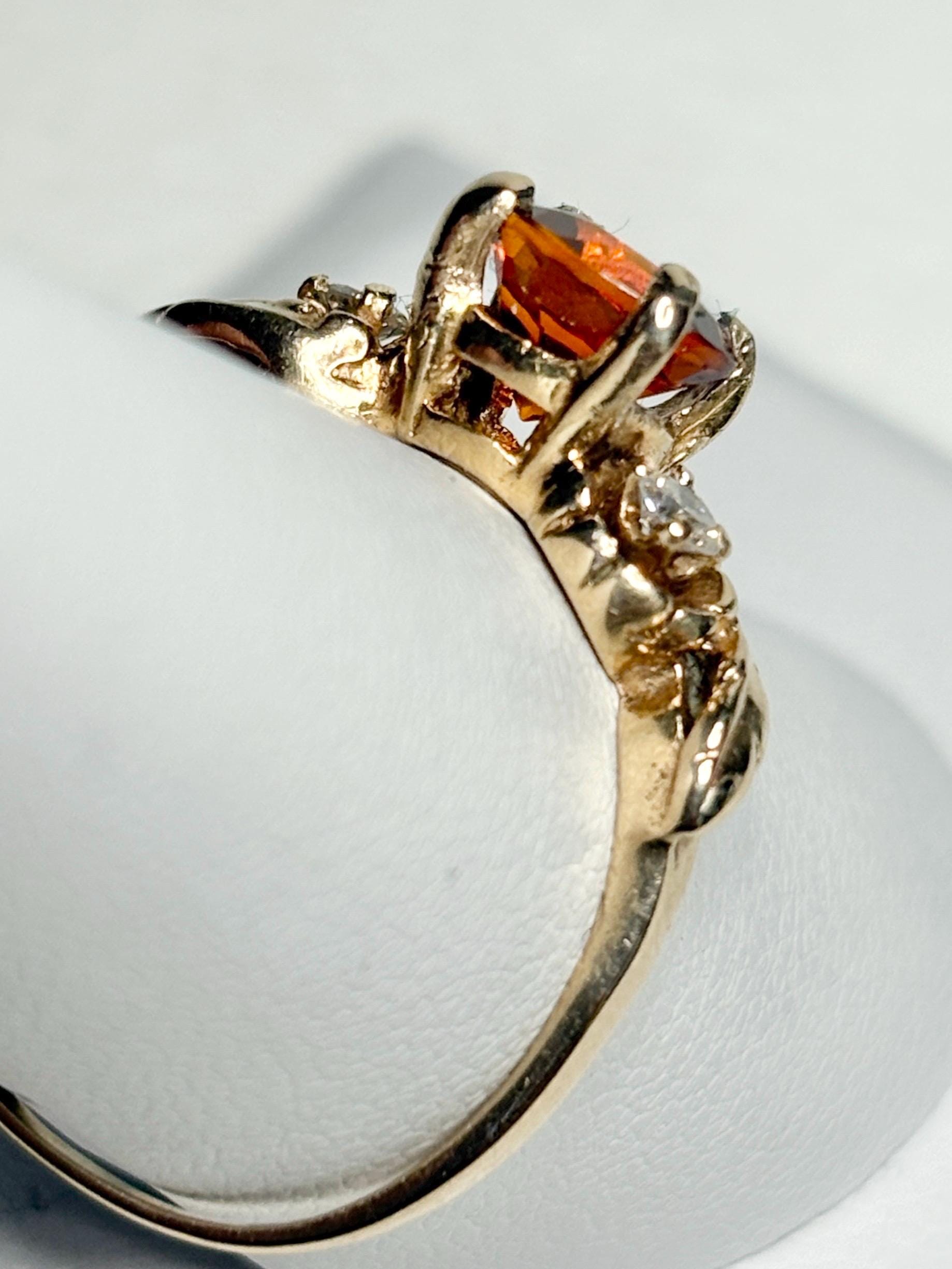 A 14k gold ring with a Madeira citrine and diamond accents.