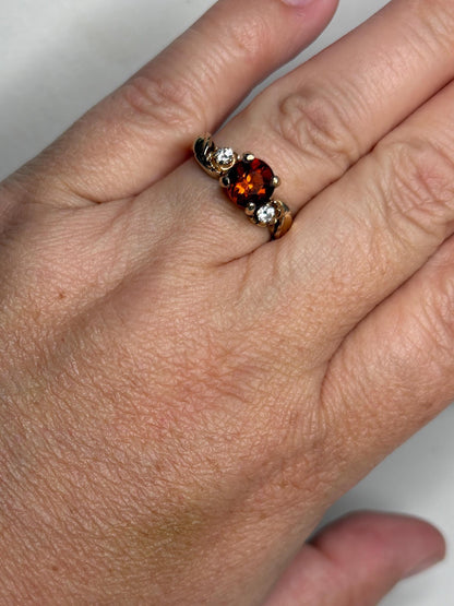 14k gold ring with a Madeira citrine and two diamonds in a floral design.