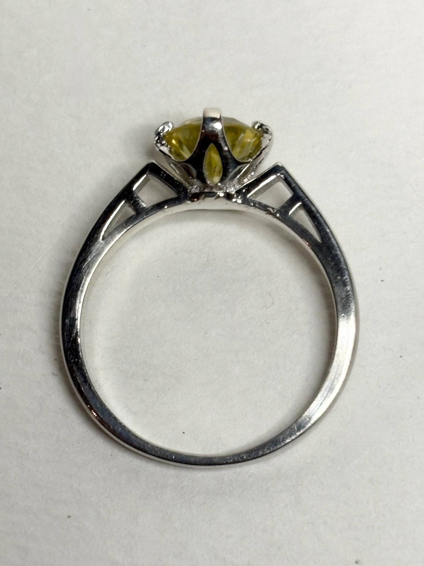 Sterling silver ring with a yellow moissanite solitaire stone.