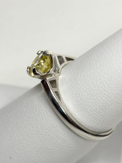 Sterling silver ring with a yellow moissanite solitaire stone.