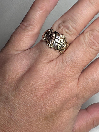 Black Hills Gold ring with diamonds and tri-color leaves.