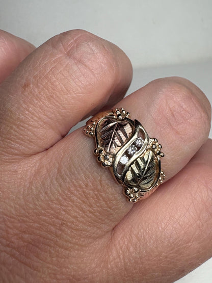 Black Hills Gold ring with diamonds and tri-color gold leaves.