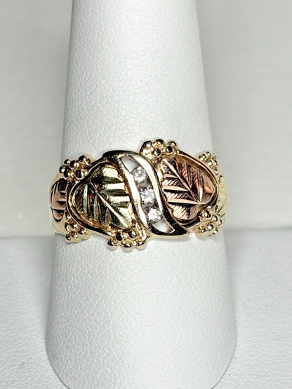 Black Hills Gold ring with three diamonds and tri-color gold leaves.