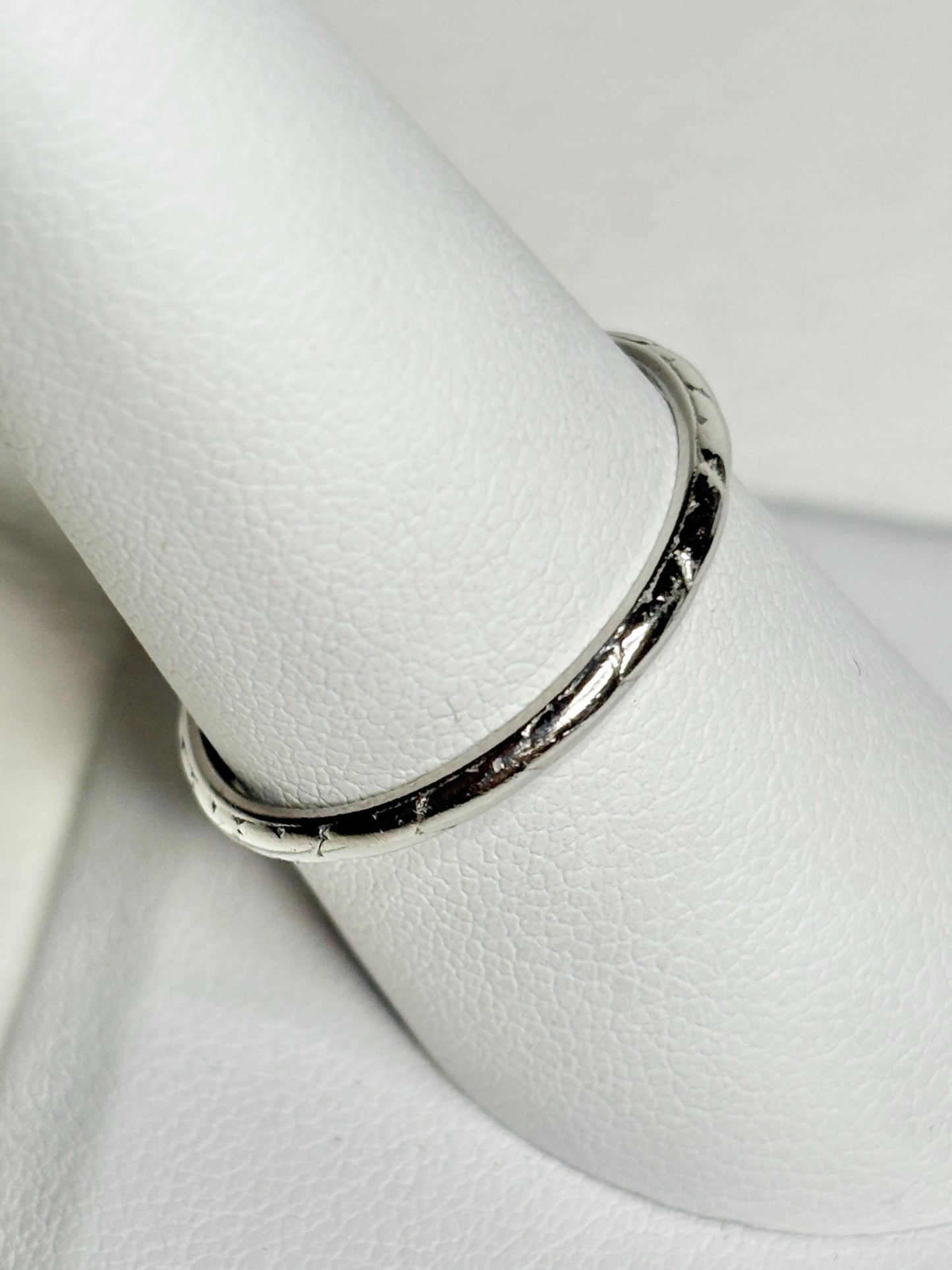 Art Deco platinum iridium chevron thin band ring with textured detail.