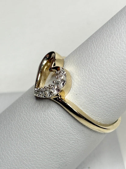 A 10k yellow gold ring with a heart-shaped diamond cluster.
