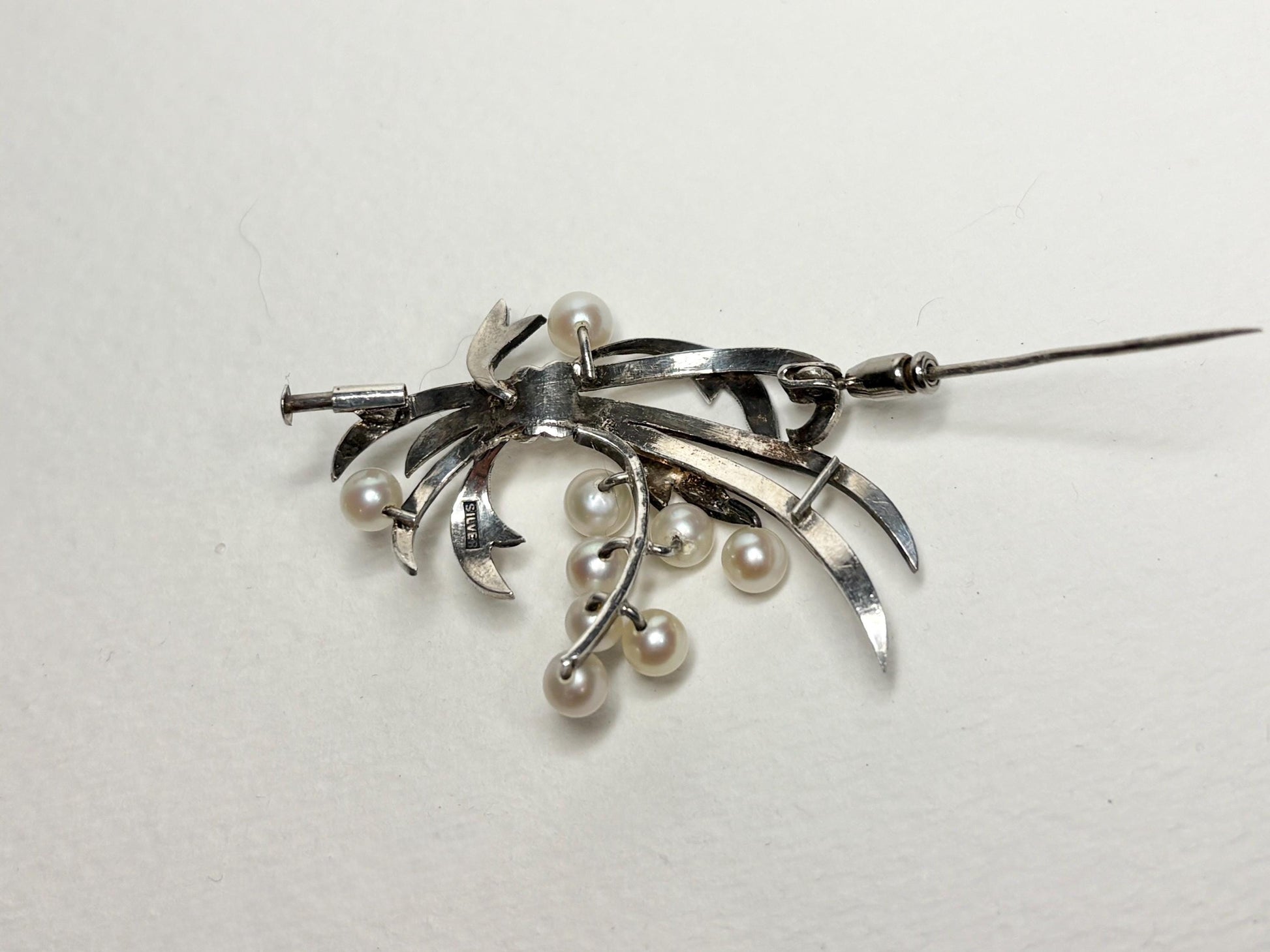 Vintage sterling silver brooch with Akoya cultured pearls and a bow design.