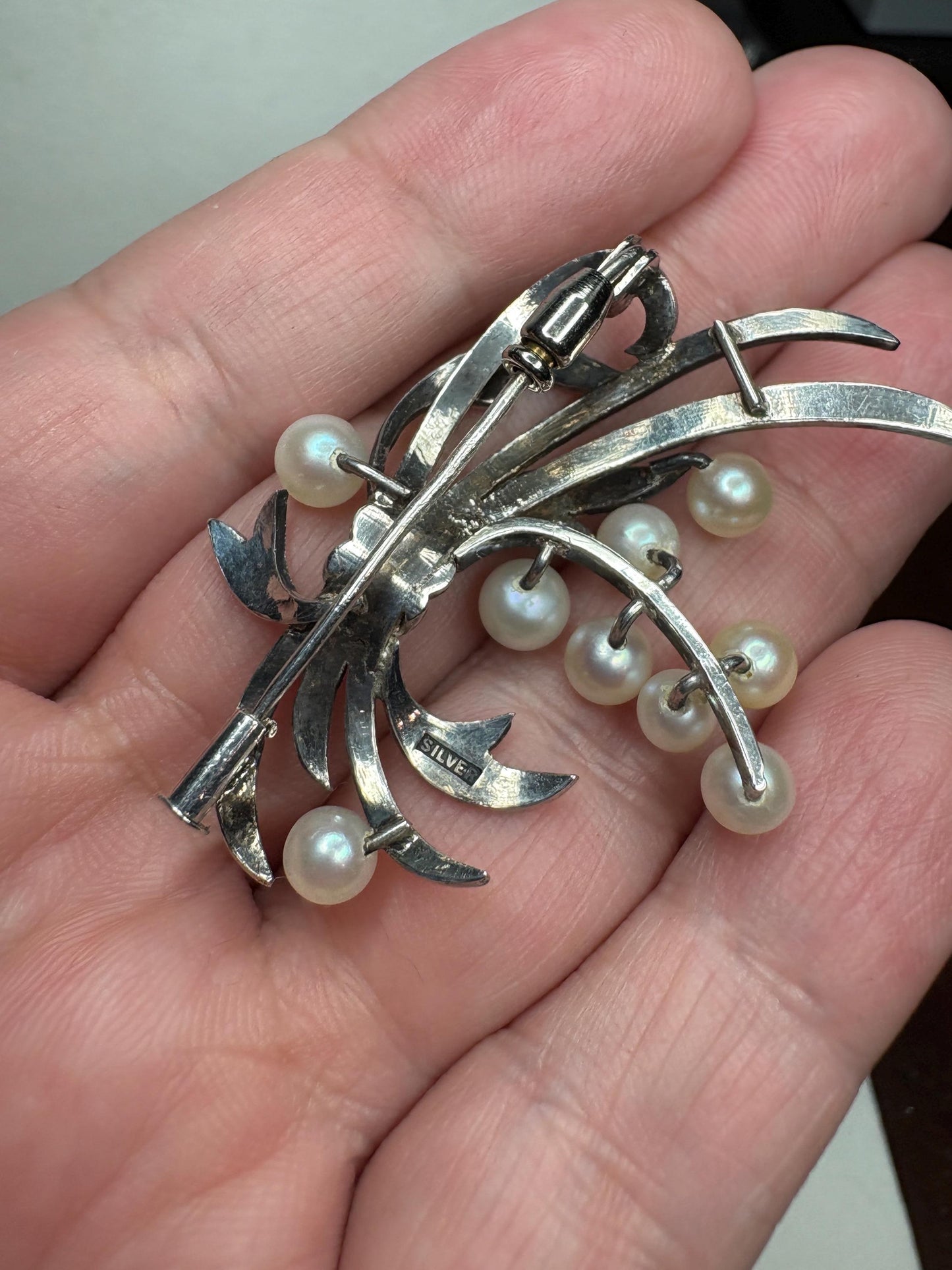 Vintage sterling silver bow brooch with nine Akoya cultured pearls.