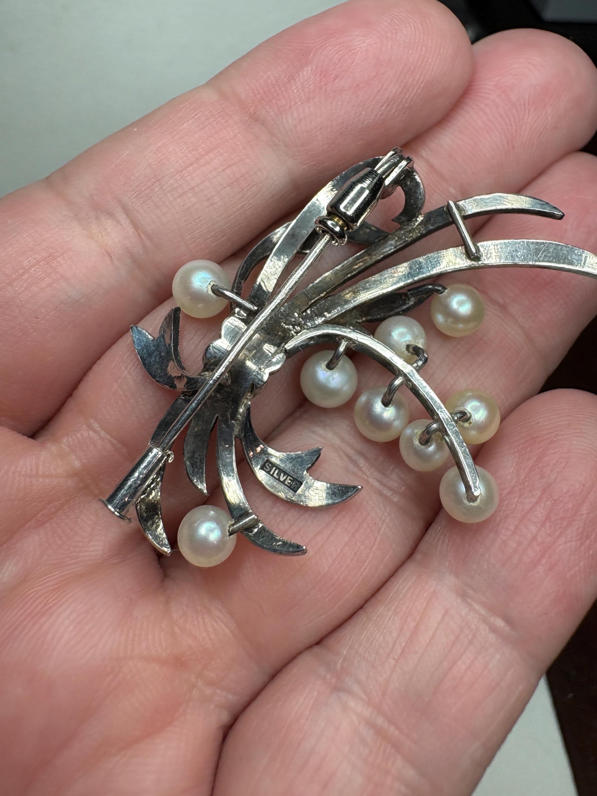 Vintage sterling silver bow brooch with nine Akoya cultured pearls.