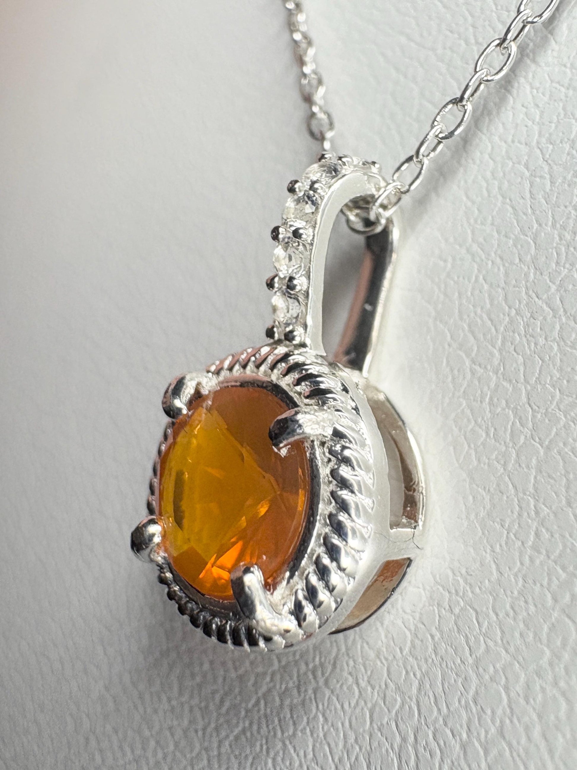 Sterling silver pendant necklace with a round Oregon fire opal and white topaz accents.