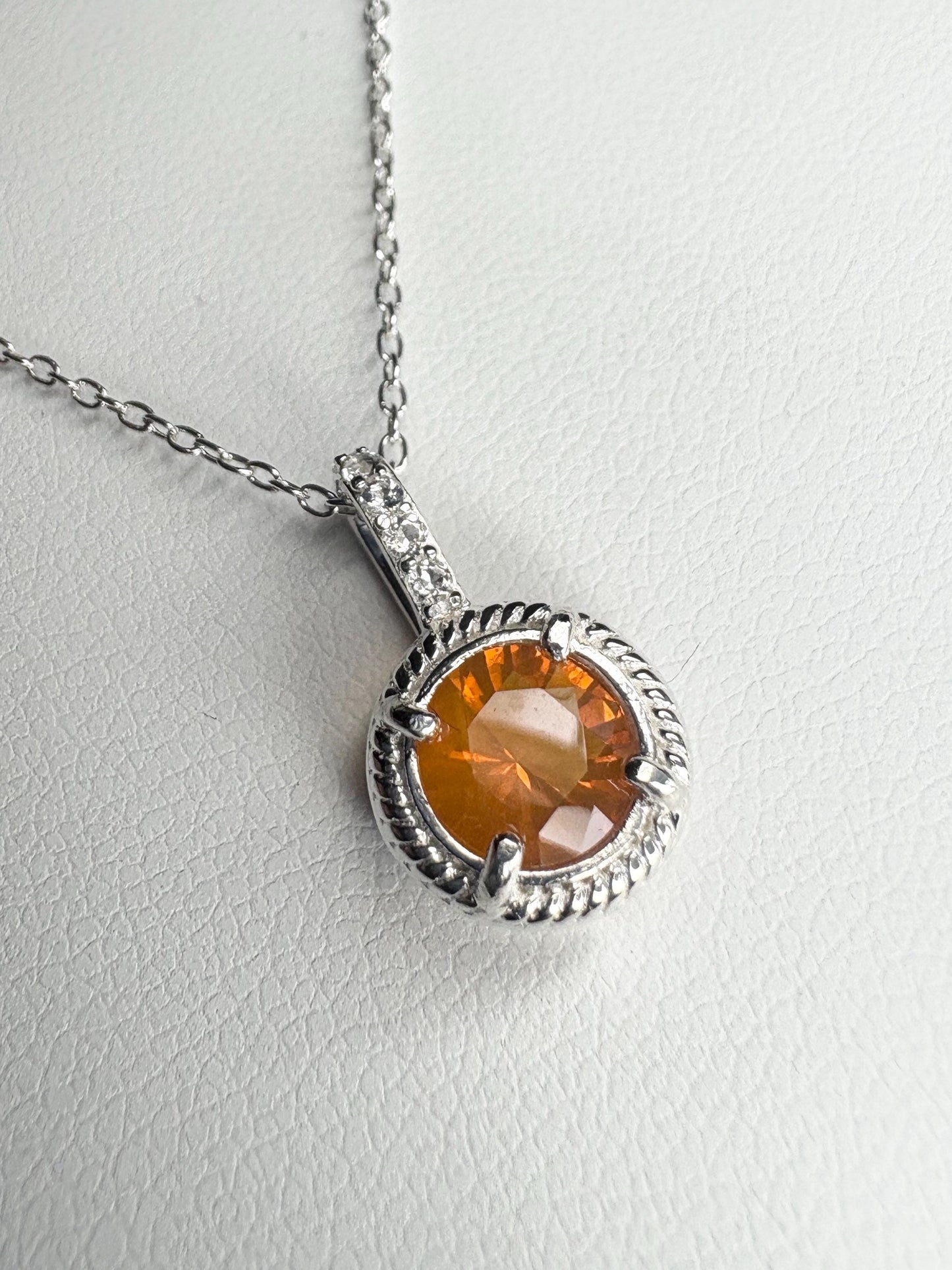 Sterling silver pendant necklace with a round Oregon fire opal and white topaz accents.