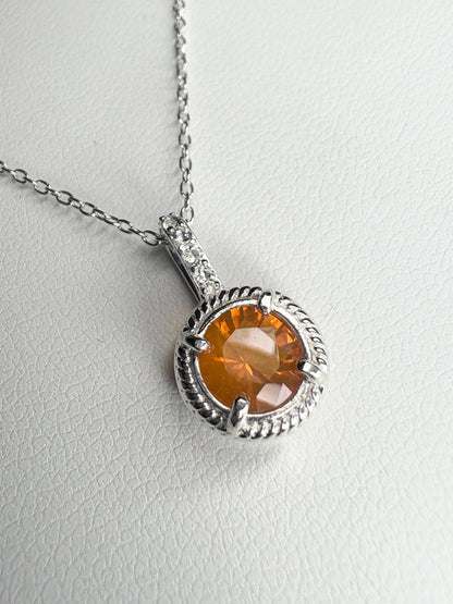 Sterling silver pendant necklace with a round Oregon fire opal and white topaz accents.