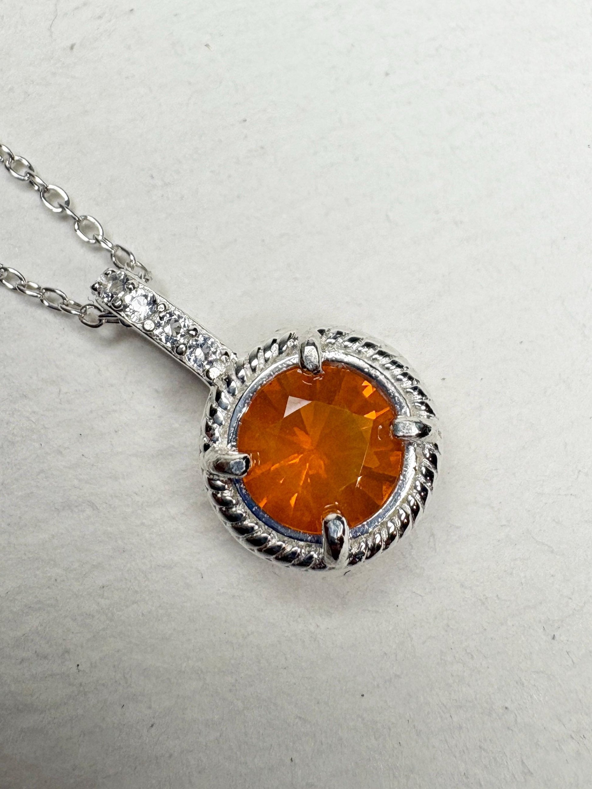Sterling silver pendant necklace with an Oregon fire opal and white topaz accents.