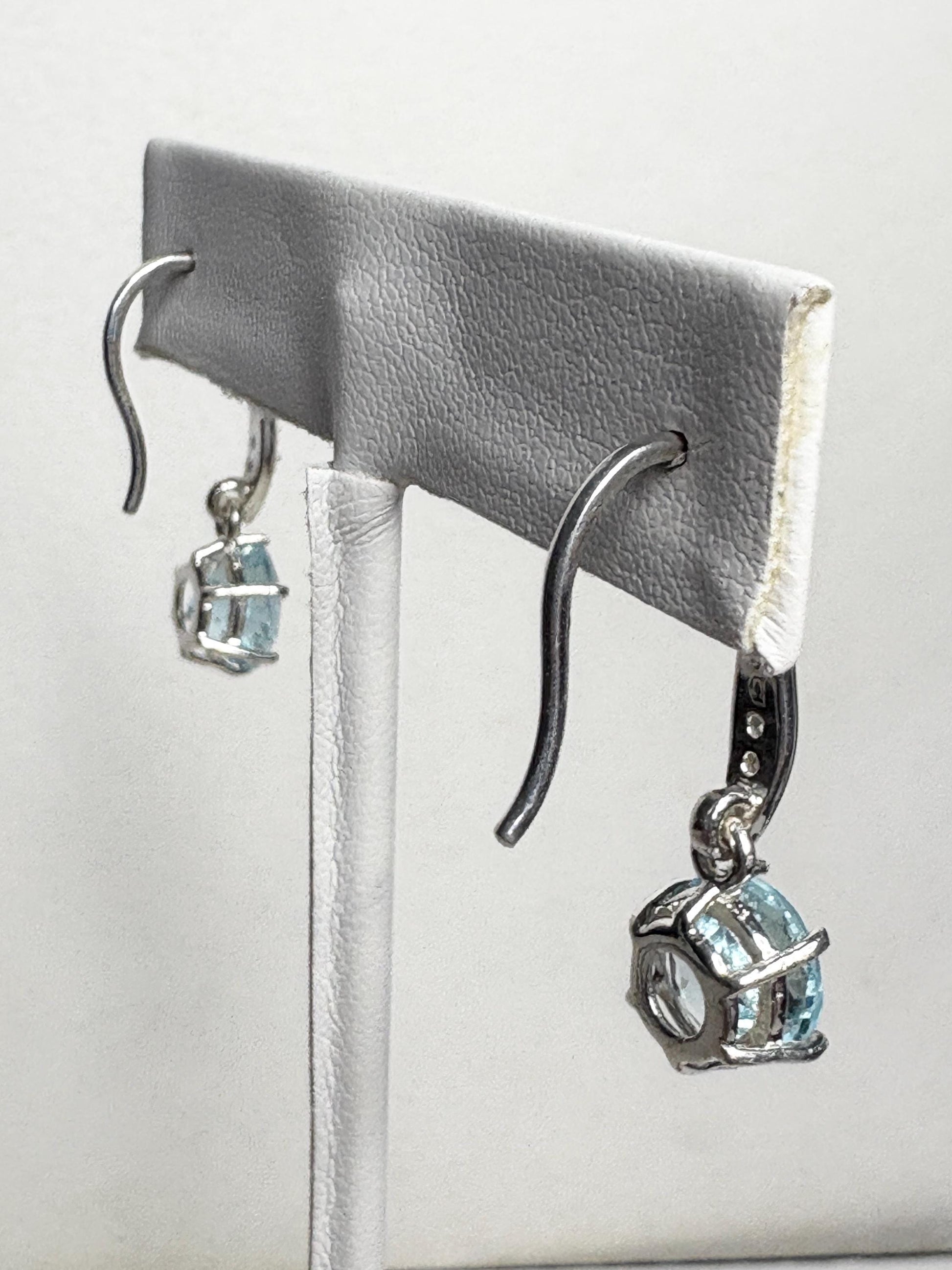 Sterling silver dangle earrings with blue topaz and white zircon.