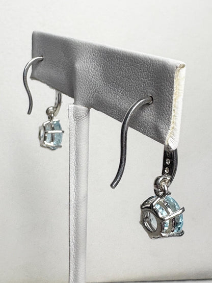 Sterling silver dangle earrings with blue topaz and white zircon.