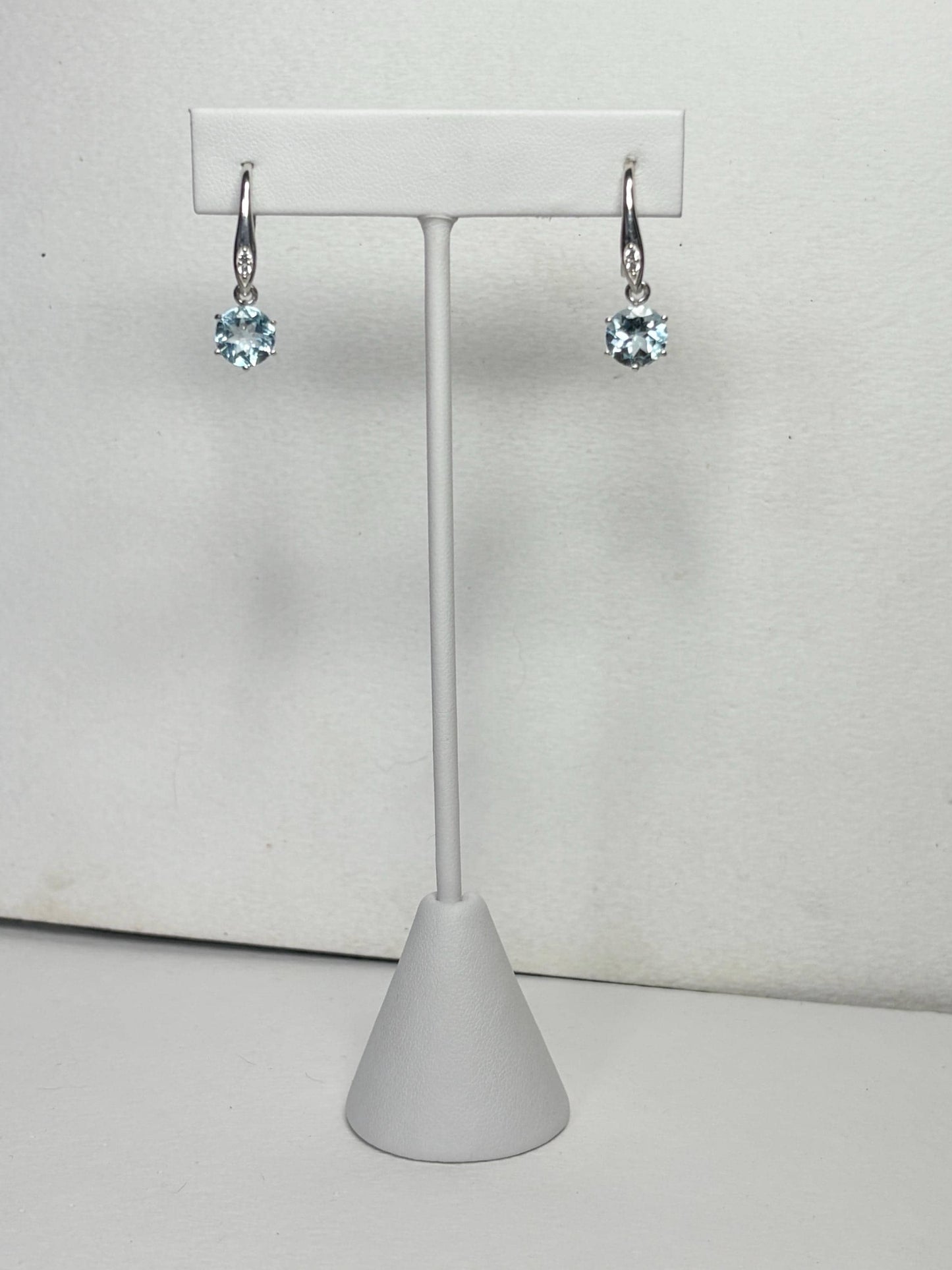 Sterling silver dangle earrings with blue topaz and white zircon.