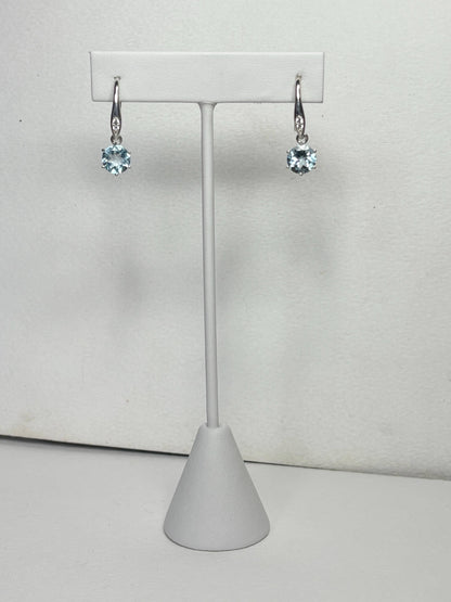 Sterling silver dangle earrings with blue topaz and white zircon.