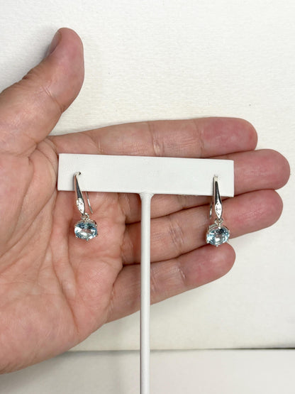 Sterling silver dangle earrings with blue topaz and white zircon.