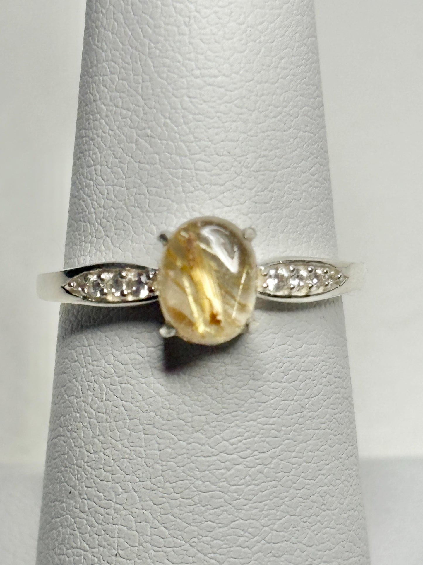 Sterling silver ring with rutilated quartz and zircon accents.