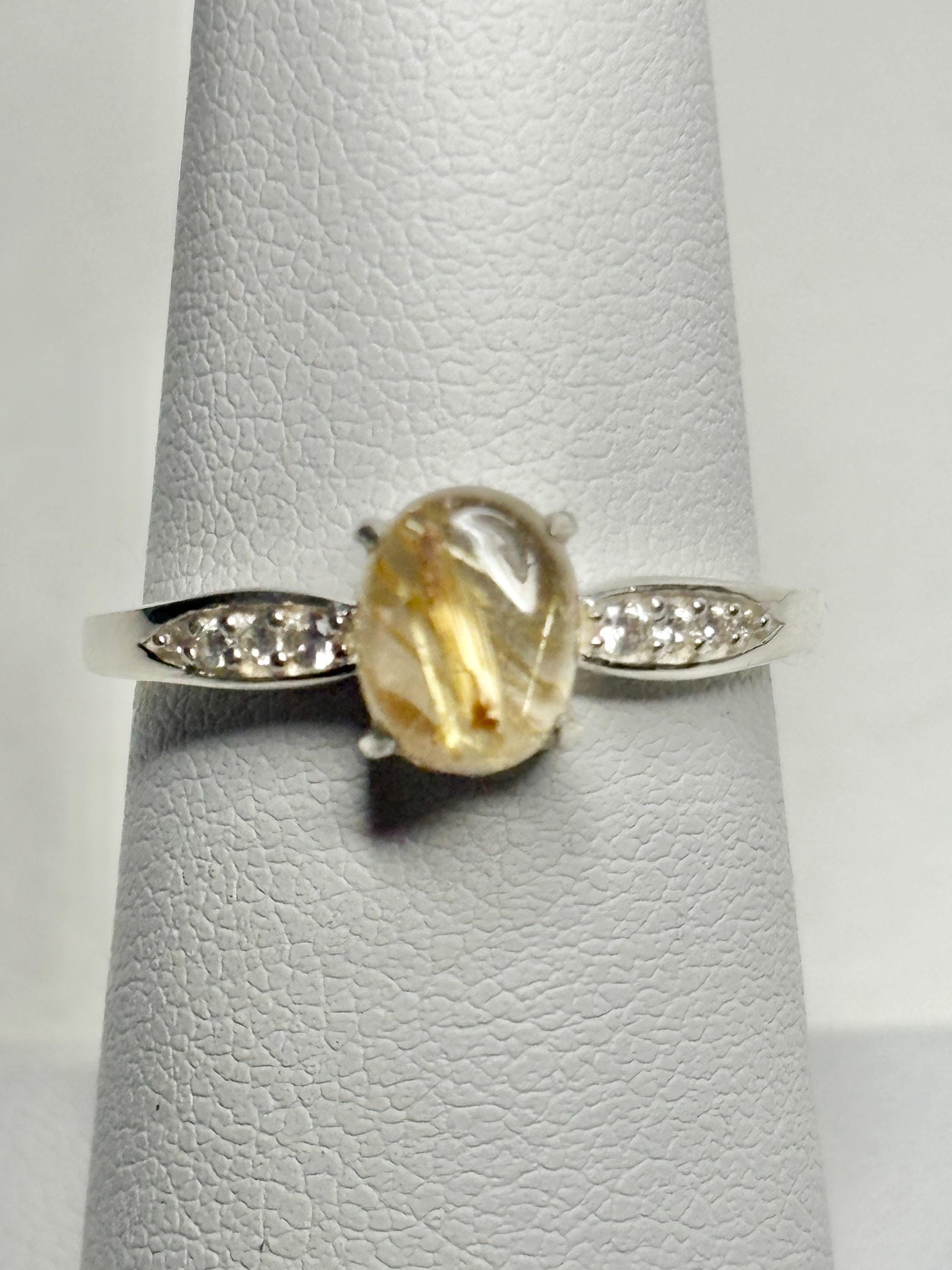 Sterling silver ring with rutilated quartz and zircon accents.