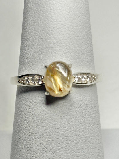 Sterling silver ring with rutilated quartz and zircon accents.