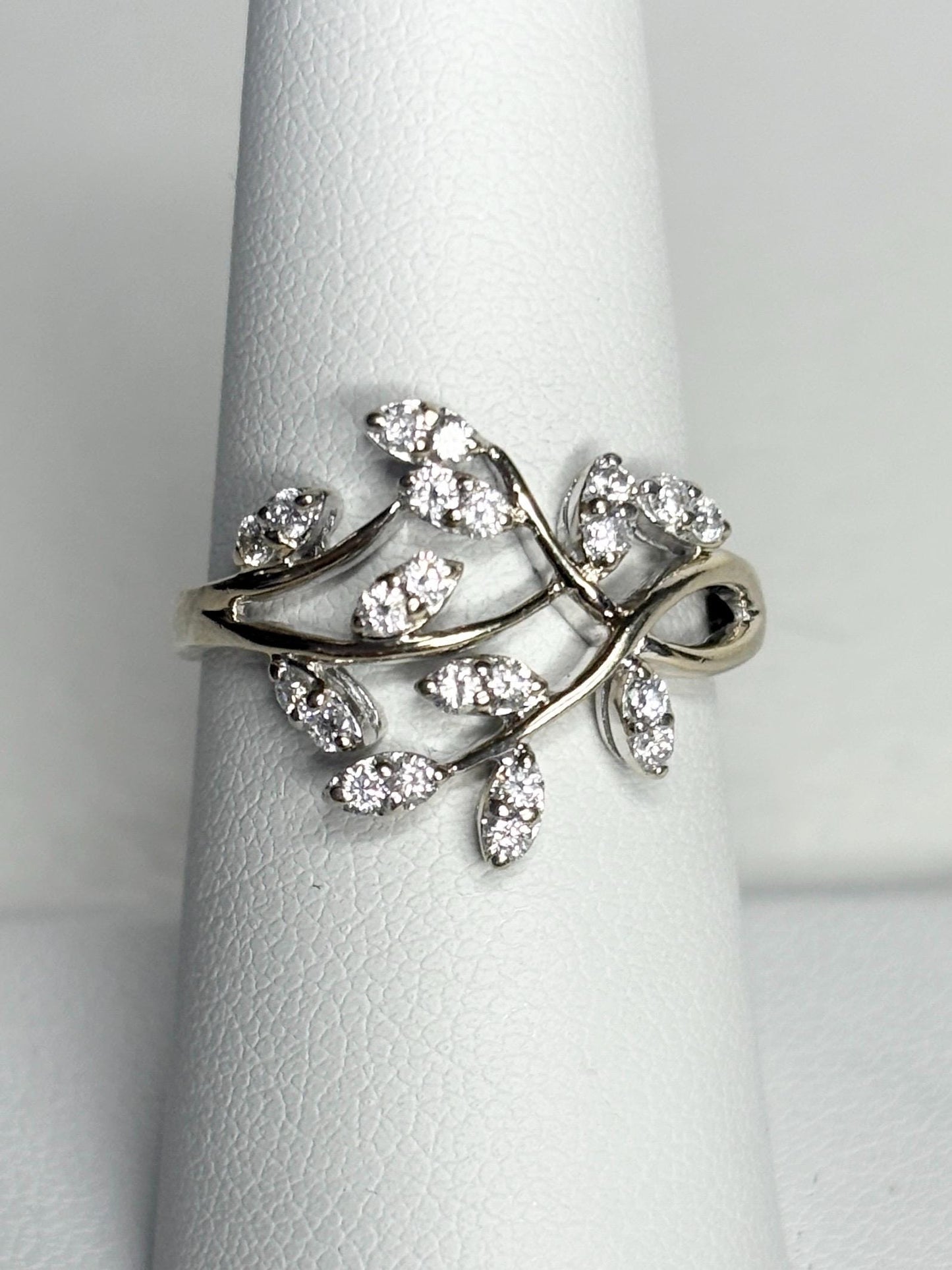 A 14k white gold ring with a vine design and approximately 1/2 carat of diamonds.