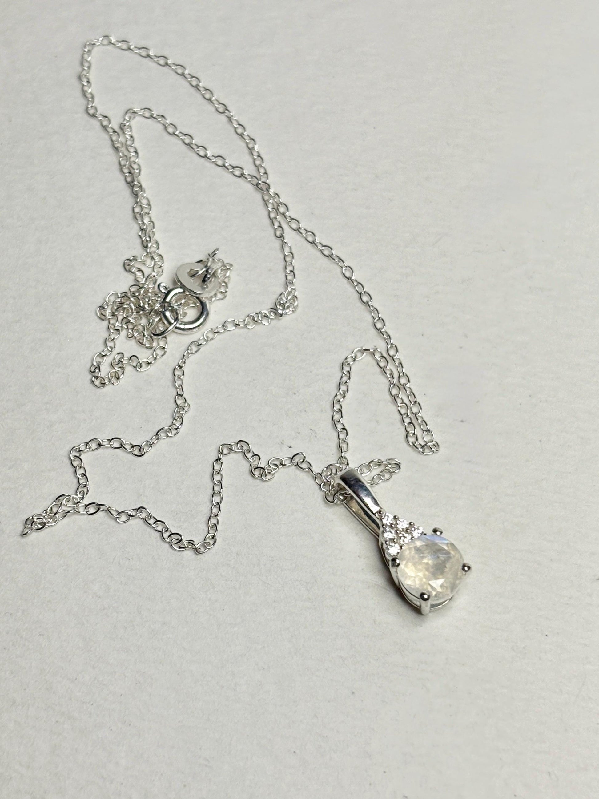 Sterling silver necklace with rainbow moonstone and zircon pendant.