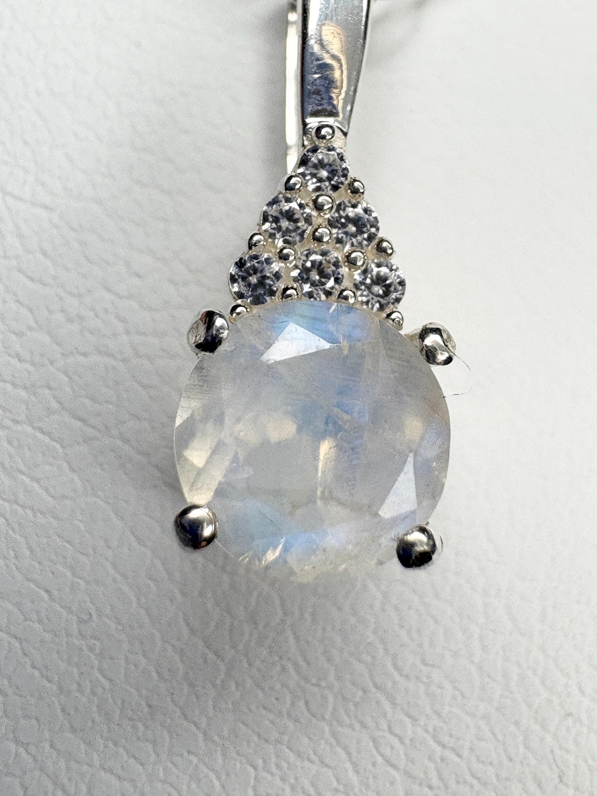 Sterling silver pendant with rainbow moonstone and zircon accents.