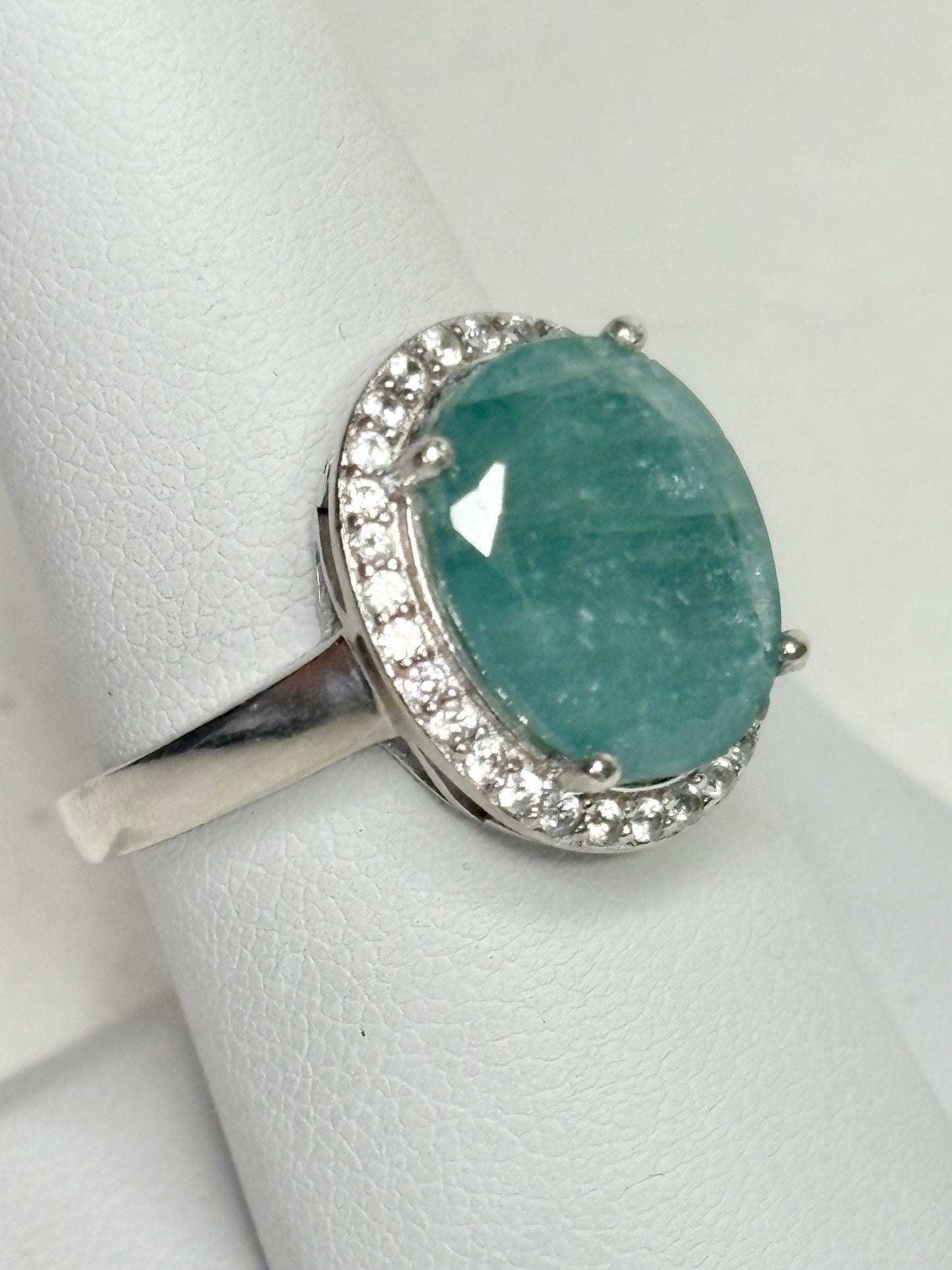 Sterling silver ring with a large oval grandidierite and zircon halo.