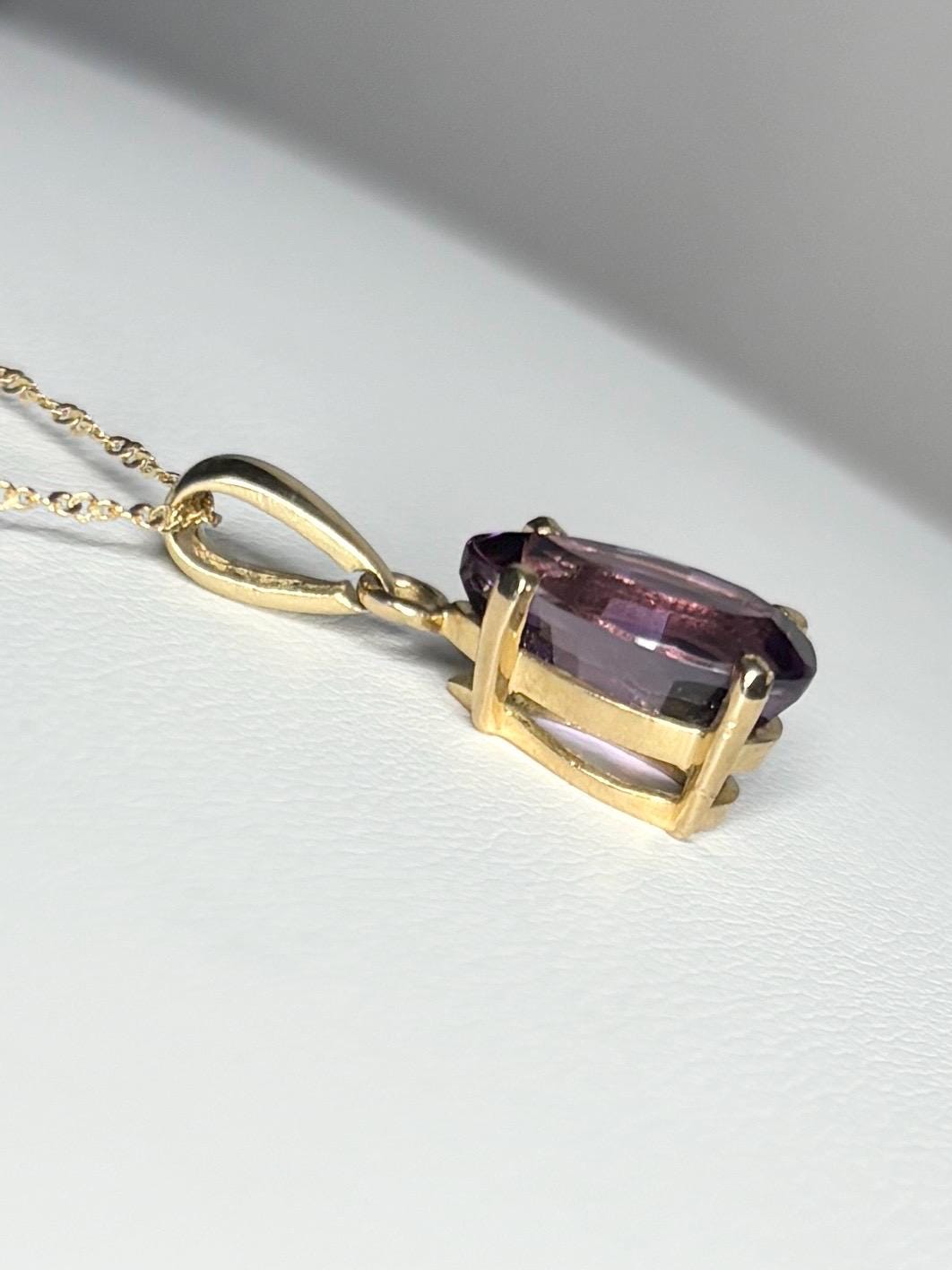 14k gold pendant necklace with a step-cut pear-shaped amethyst.