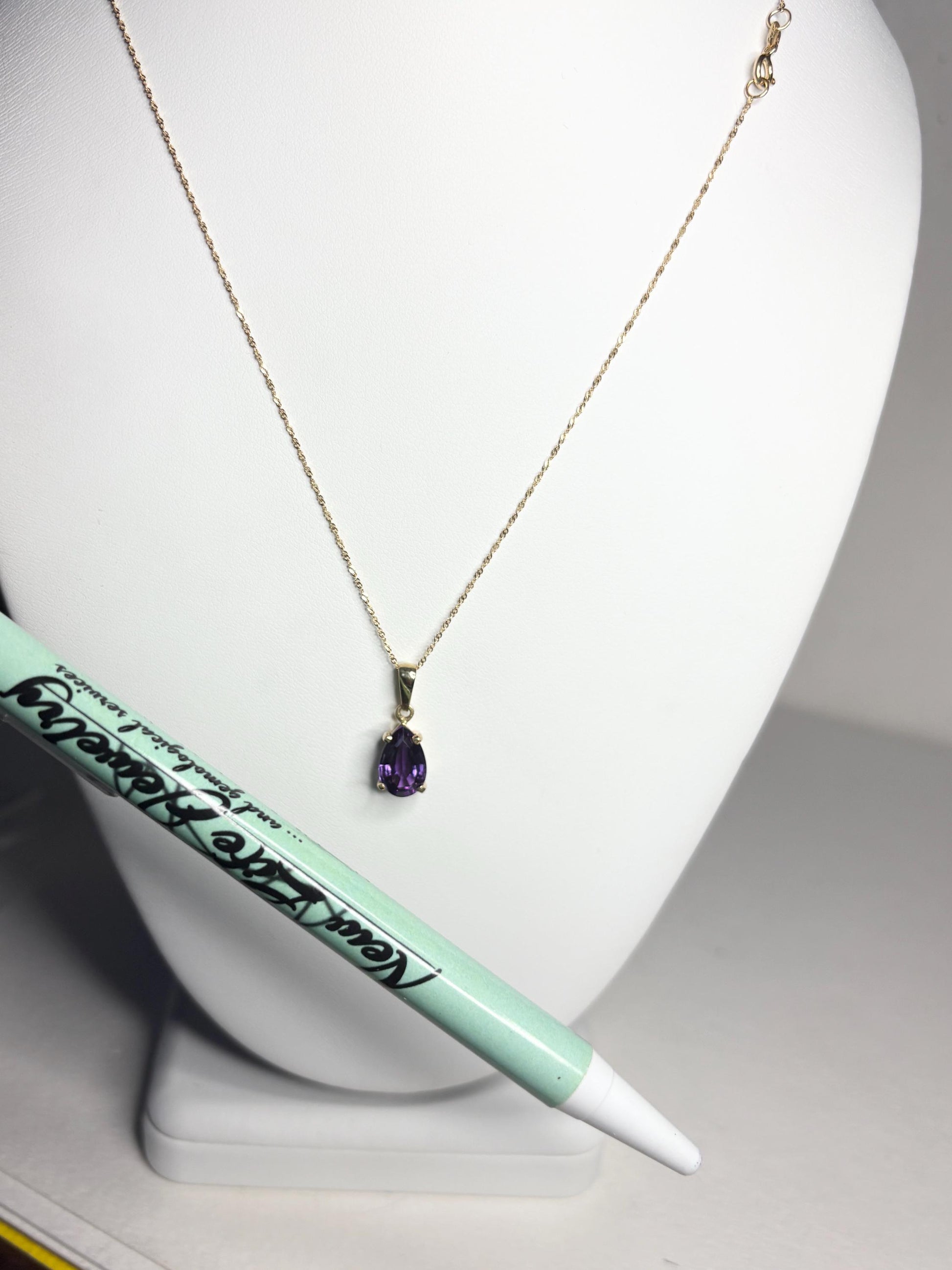 14k gold necklace with a pear-shaped amethyst pendant.