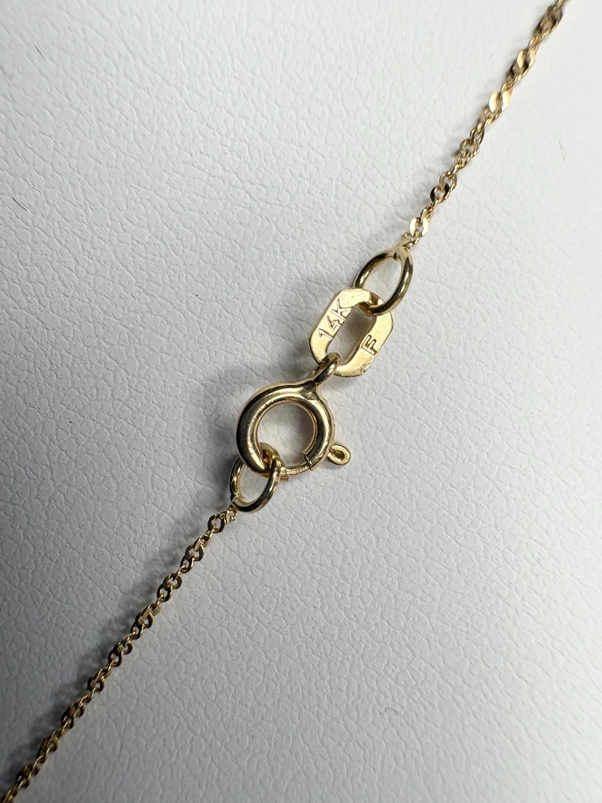 A 14k gold necklace with a clasp and chain detail.