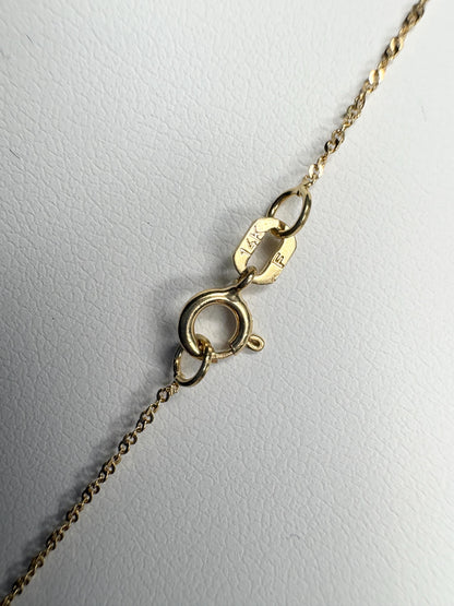 A 14k gold necklace with a clasp and chain detail.