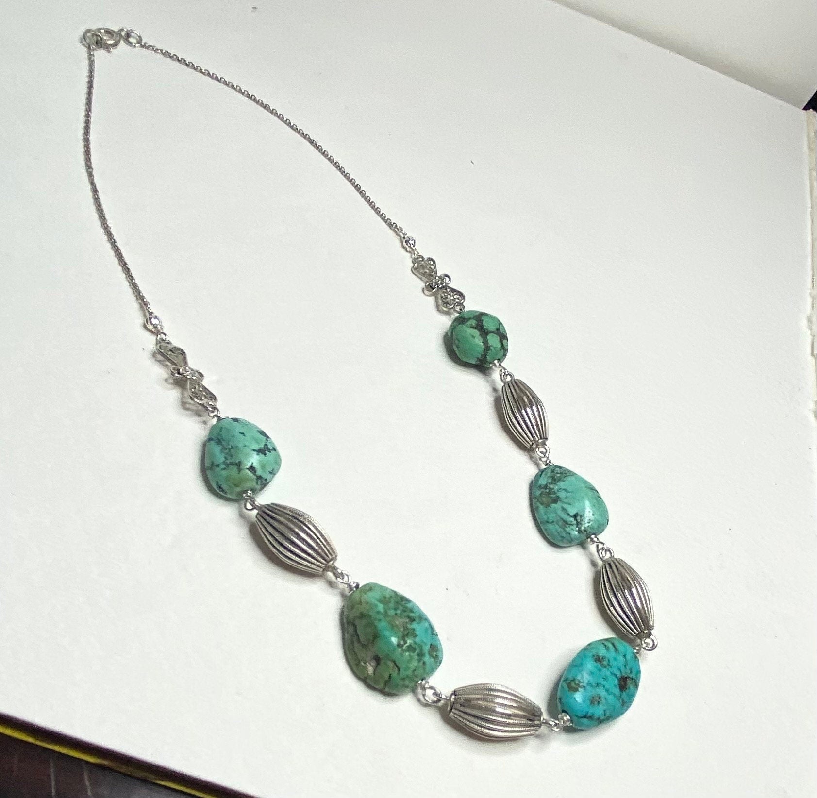 Turquoise beaded necklace with silver accents.