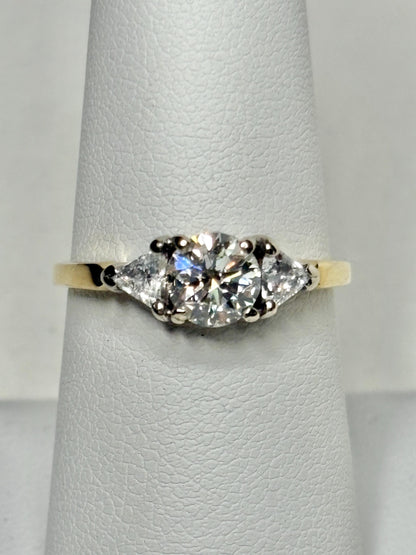 GIA certified diamond ring with round and trillion stones in 18k gold.