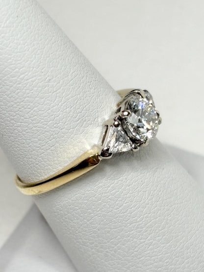 GIA certified diamond engagement ring with round and trillion stones in 18k gold.
