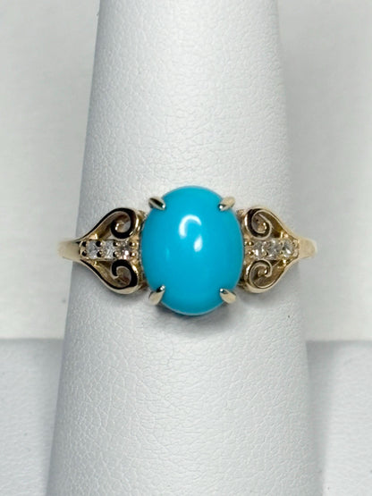 A 10k gold ring with an oval Sleeping Beauty turquoise and accent diamonds.