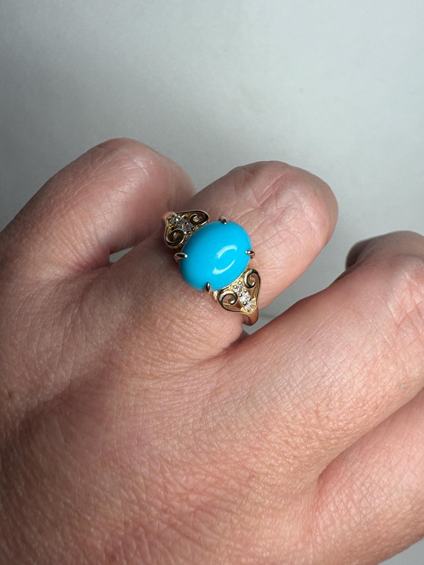A 10k gold ring with an oval Sleeping Beauty turquoise and diamonds.