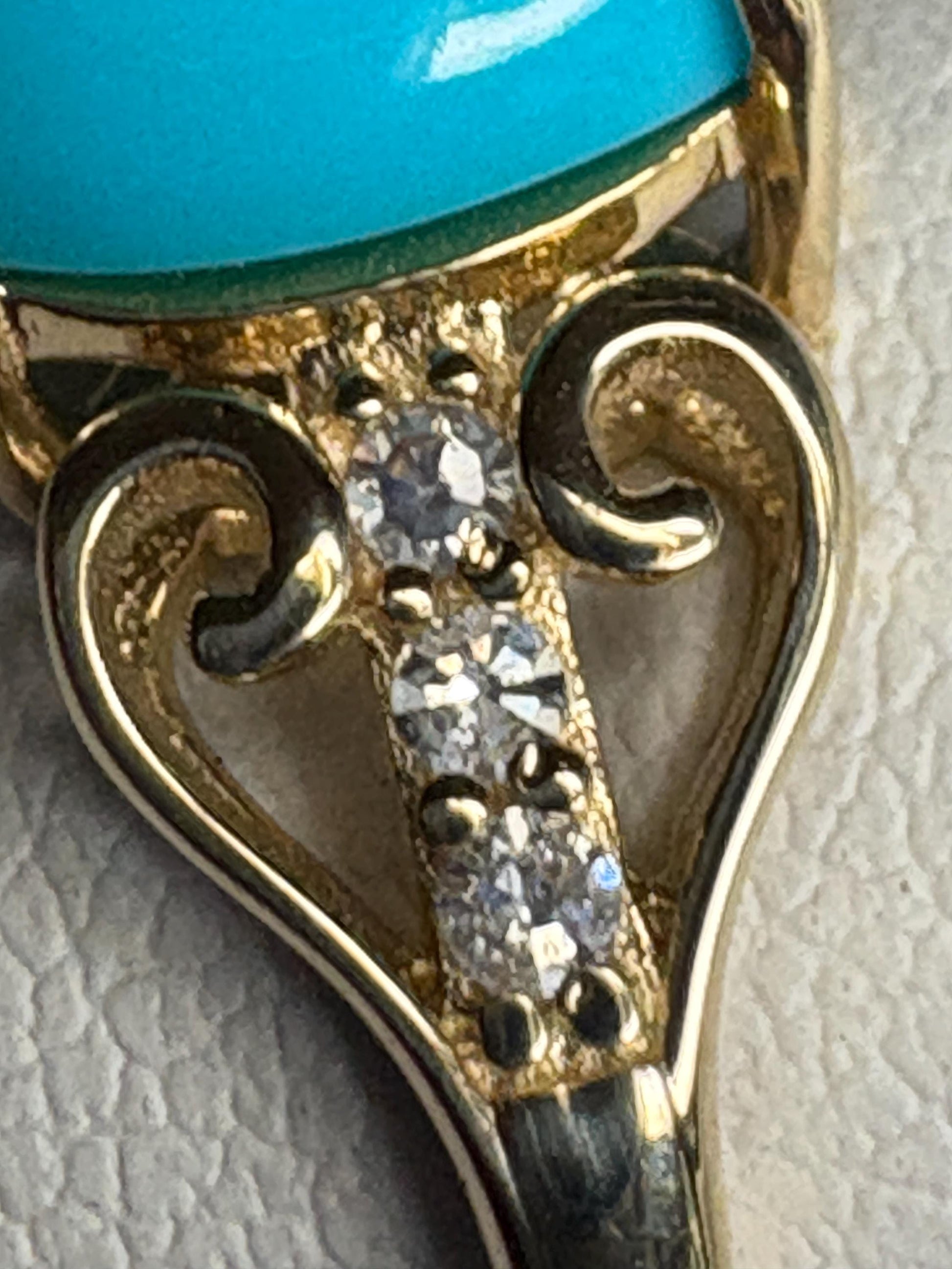 A 10k gold ring with a Sleeping Beauty turquoise stone and flanking diamonds.