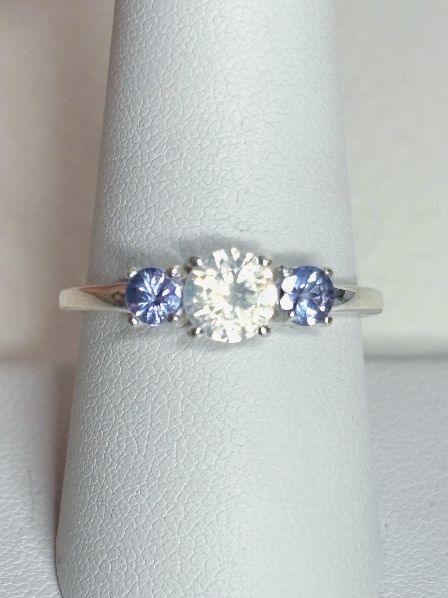Sterling silver ring with a central off-white zircon and two tanzanite stones.
